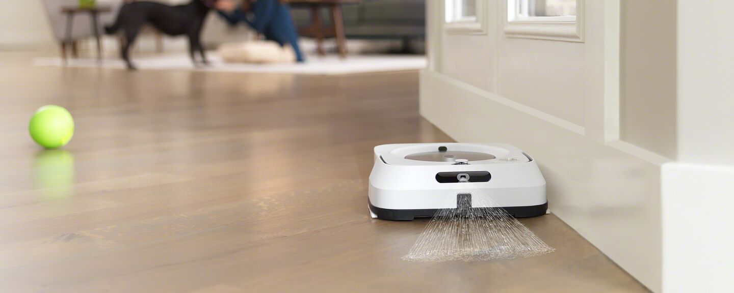 A white Braava cleaning a floor