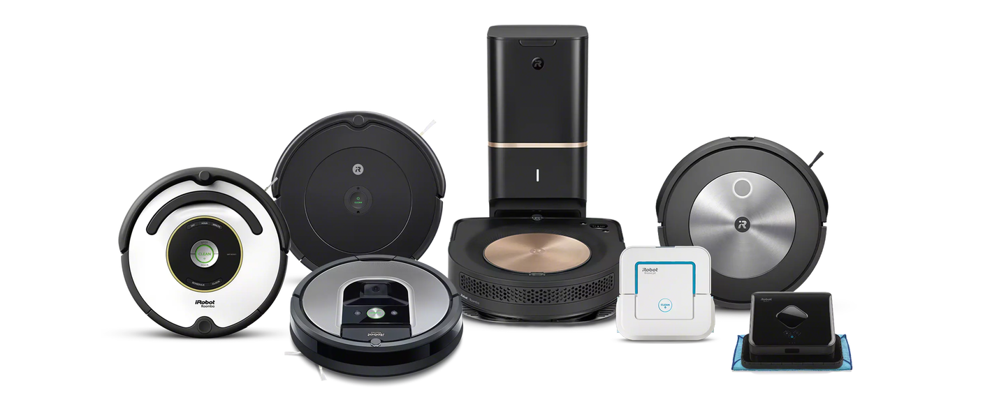 A family plays in the kitchen behind images of iRobot&rsquo;s collection of robot vacuums and mops.