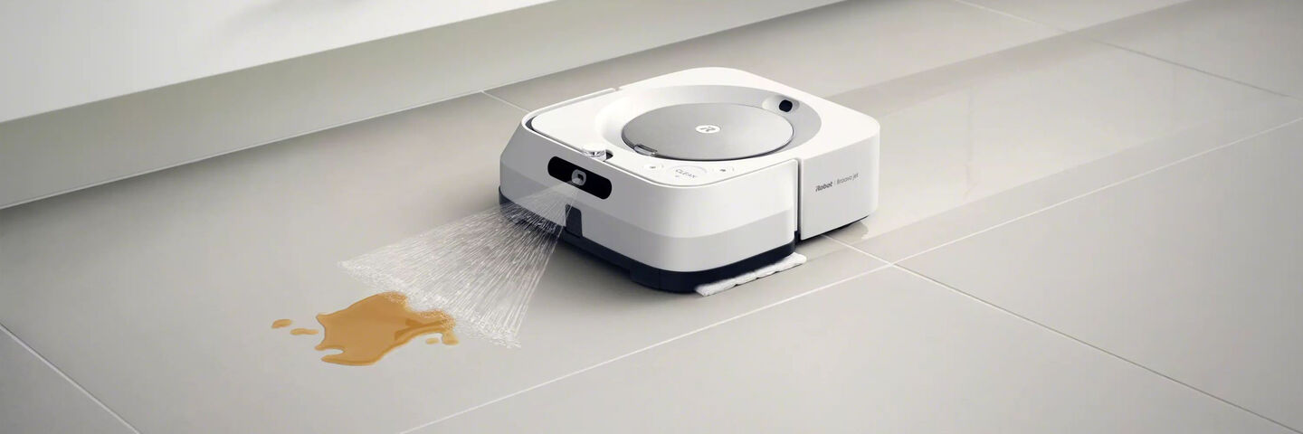 A white m6 Braava cleaning liquid off a floor